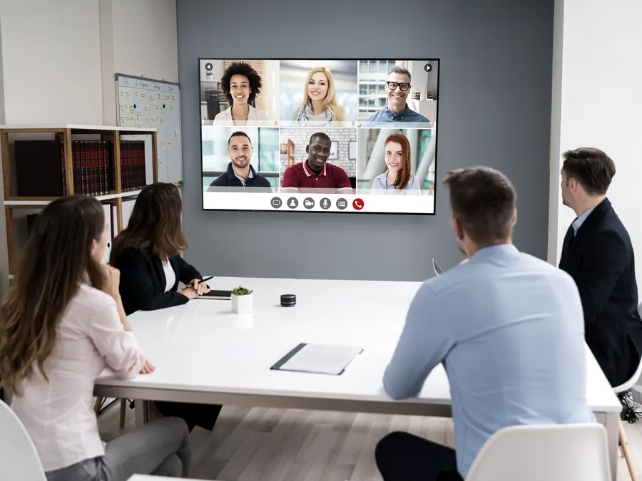 A team on a video call in a meeting room